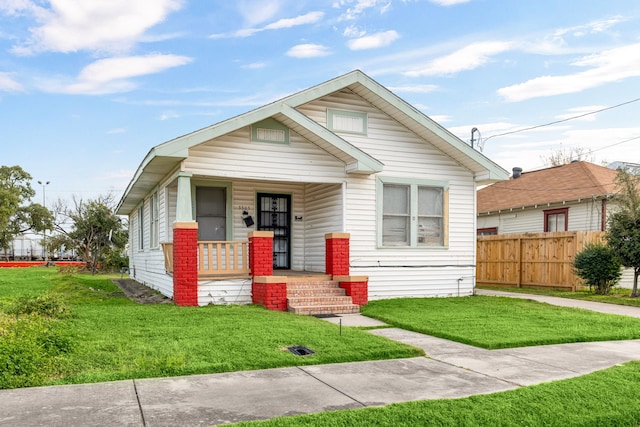 bungalow-style home featuring a porch and a front yard