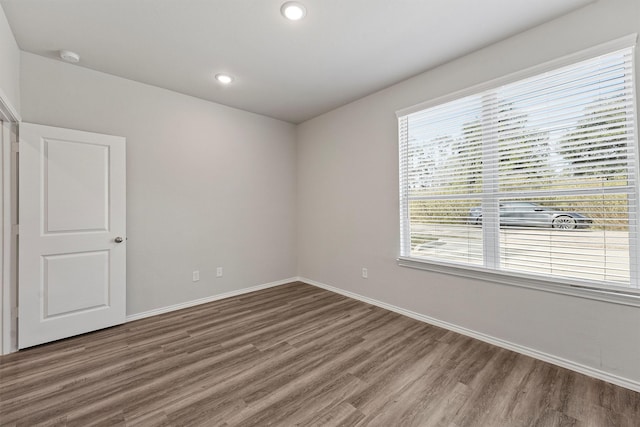 unfurnished room with dark hardwood / wood-style floors