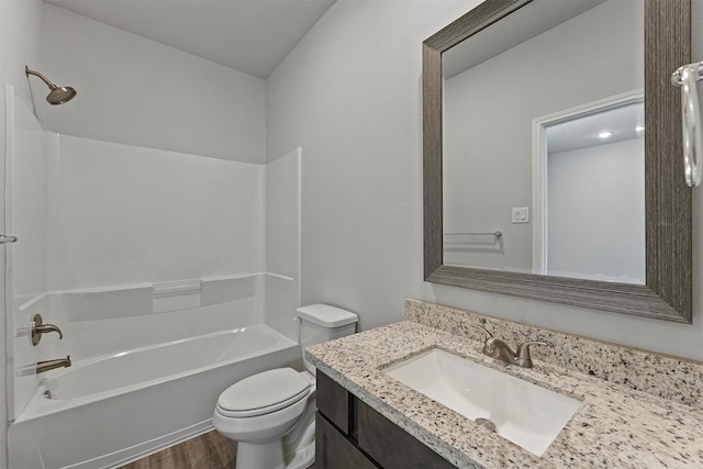 full bathroom featuring toilet, tub / shower combination, hardwood / wood-style floors, and vanity