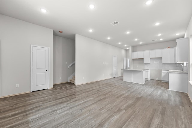 unfurnished living room with light hardwood / wood-style floors