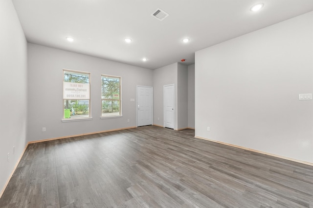 empty room with hardwood / wood-style floors