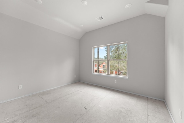 empty room featuring vaulted ceiling