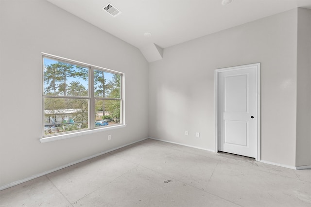 empty room featuring vaulted ceiling