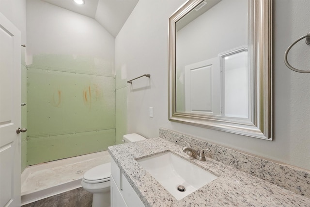 bathroom with lofted ceiling, vanity, toilet, walk in shower, and hardwood / wood-style flooring