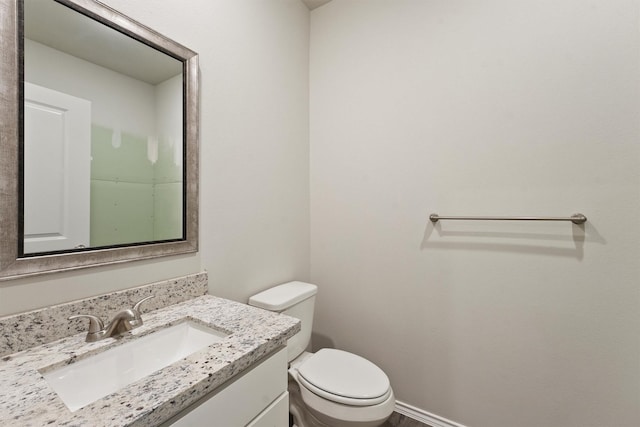 bathroom featuring toilet and vanity