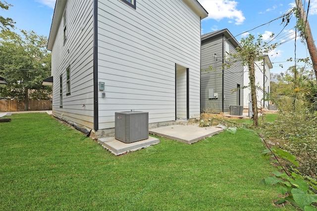 back of property with a patio area, a lawn, and central air condition unit