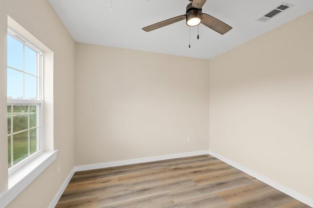 spare room with ceiling fan and wood-type flooring