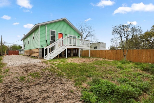 rear view of property featuring a wooden deck