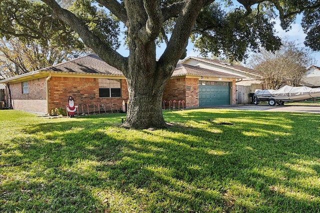 ranch-style house with a garage and a front lawn