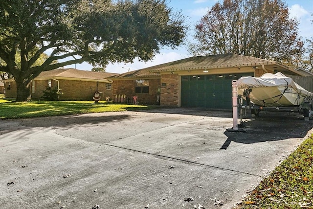 ranch-style house with a front yard and a garage