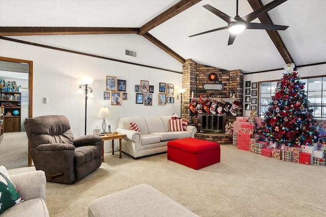 carpeted living room with ceiling fan, lofted ceiling with beams, and a fireplace