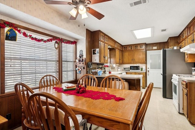 dining room featuring a textured ceiling and ceiling fan