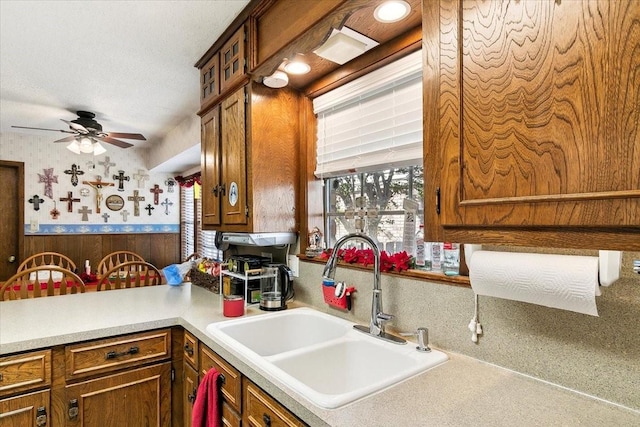 kitchen featuring ceiling fan, sink, and a textured ceiling