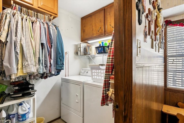 laundry room with washing machine and clothes dryer and cabinets