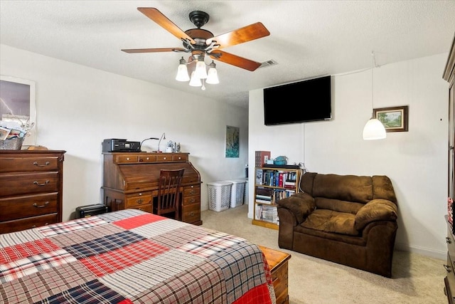 bedroom featuring ceiling fan, light colored carpet, and a textured ceiling