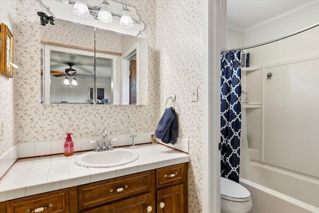 full bathroom with vanity, shower / bath combination with curtain, toilet, ornamental molding, and ceiling fan