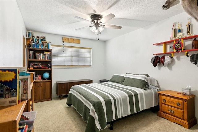 carpeted bedroom featuring a textured ceiling and ceiling fan