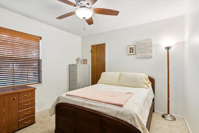 carpeted bedroom featuring ceiling fan and multiple windows