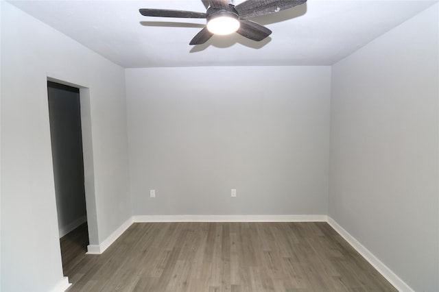 spare room featuring ceiling fan and dark wood-type flooring