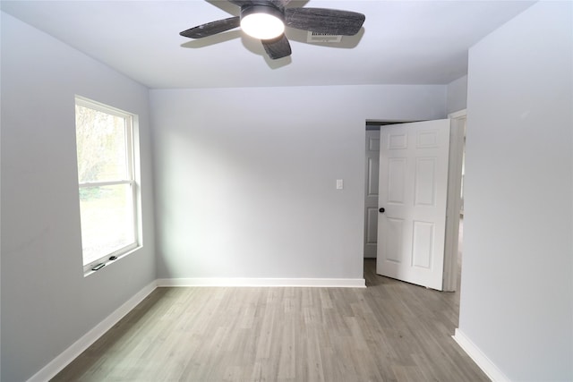 spare room with ceiling fan and light wood-type flooring