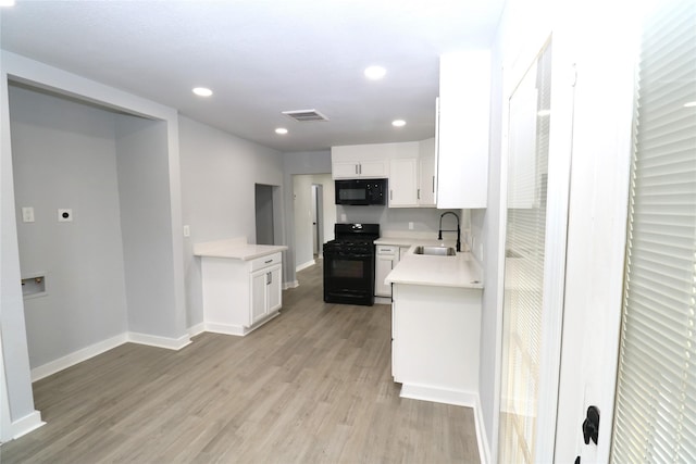 kitchen featuring light wood-type flooring, sink, white cabinets, and black appliances