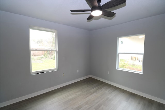 empty room featuring ceiling fan and hardwood / wood-style floors