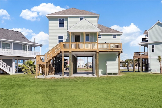 rear view of house featuring a patio, a yard, and a deck