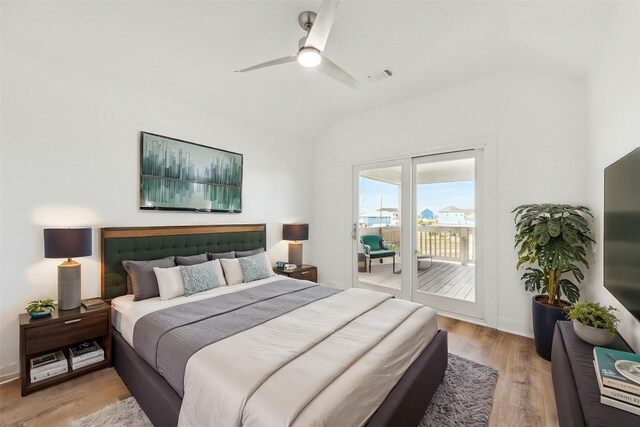 bedroom with vaulted ceiling, access to exterior, ceiling fan, and light hardwood / wood-style flooring