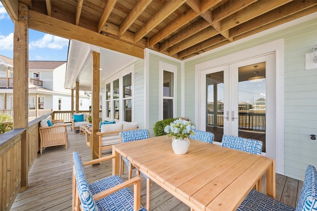 wooden deck with an outdoor living space and french doors