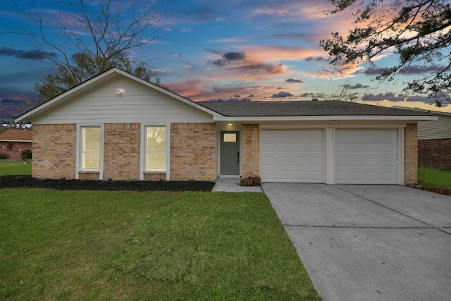 single story home with a garage and a lawn