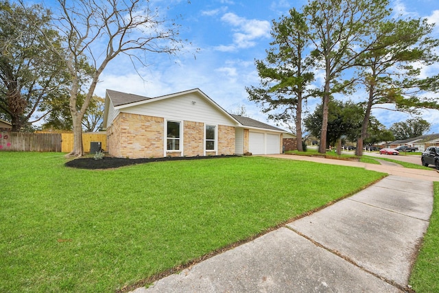 ranch-style house featuring a front lawn and a garage