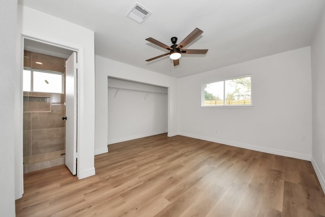 unfurnished bedroom with ceiling fan, light wood-type flooring, and a closet