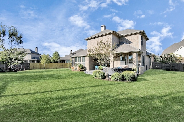 back of house featuring a yard