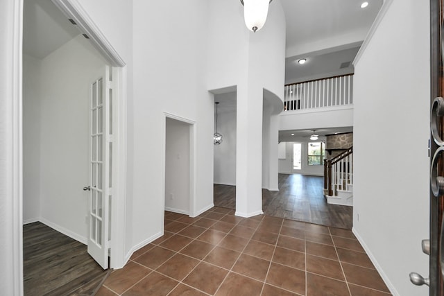 tiled foyer featuring a high ceiling and french doors