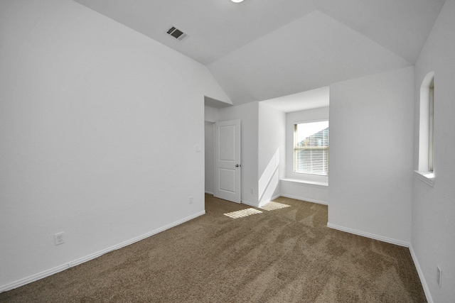 bonus room featuring dark colored carpet and vaulted ceiling