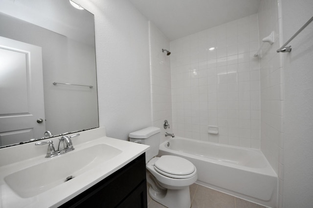 full bathroom featuring tile patterned floors, toilet, tiled shower / bath, and vanity