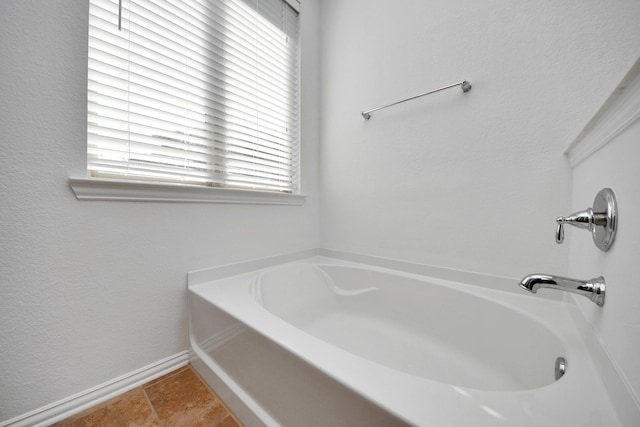 bathroom featuring a washtub and tile patterned floors