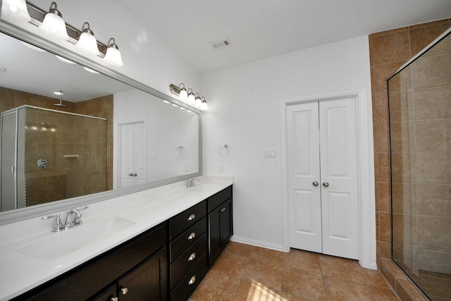 bathroom with a shower with shower door and vanity