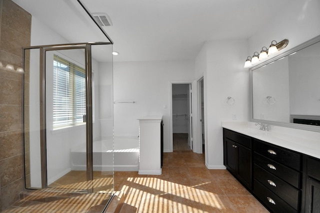 bathroom featuring vanity, a shower with door, and tile patterned flooring