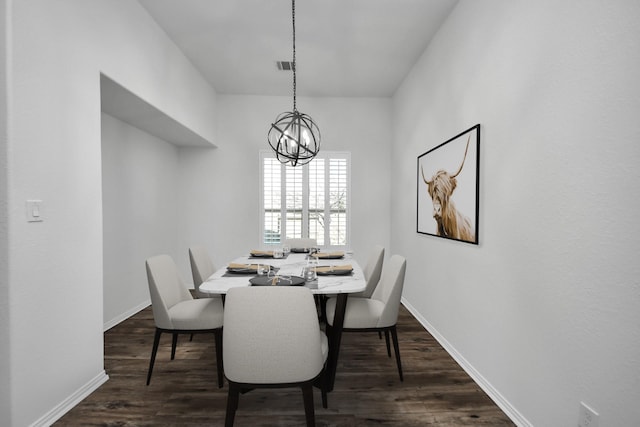 dining room featuring dark wood-type flooring and a notable chandelier