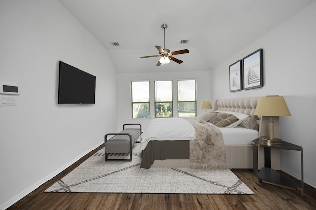 bedroom featuring ceiling fan, dark wood-type flooring, and lofted ceiling