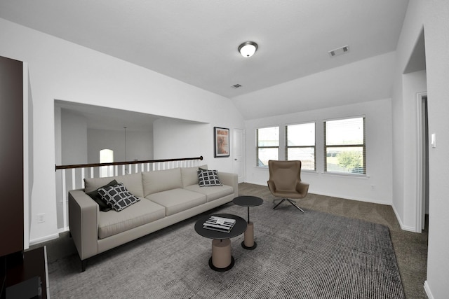 carpeted living room with vaulted ceiling