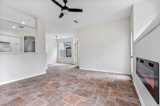 unfurnished living room featuring ceiling fan