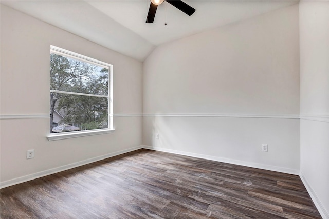 empty room featuring ceiling fan, dark hardwood / wood-style flooring, and vaulted ceiling