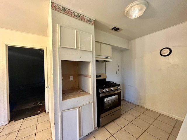 kitchen with white cabinetry, stainless steel range oven, and light tile patterned flooring