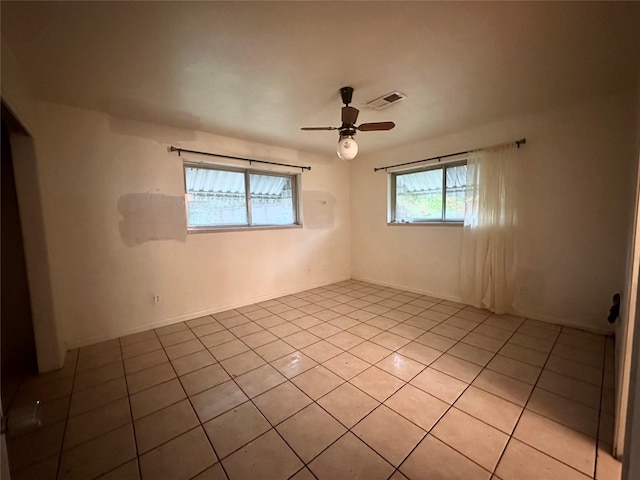 tiled empty room with ceiling fan