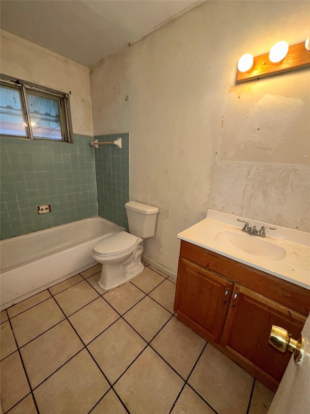 full bathroom featuring toilet, vanity, tiled shower / bath, and tile patterned flooring