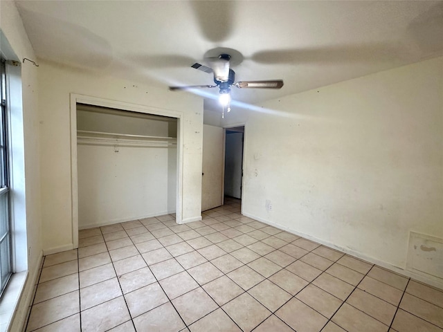 unfurnished bedroom with ceiling fan, a closet, and light tile patterned flooring