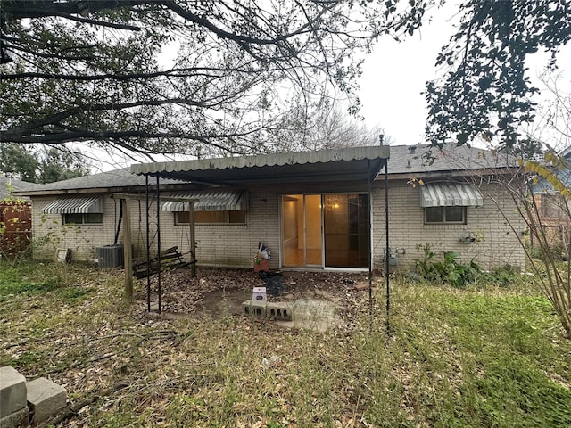 back of house with central AC unit