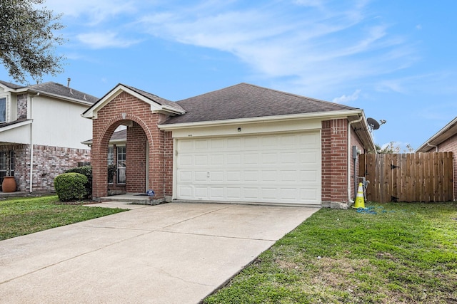 ranch-style house featuring a garage and a front lawn